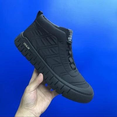 Gray high-top lace-up winter boot held in hand with thick rubber sole