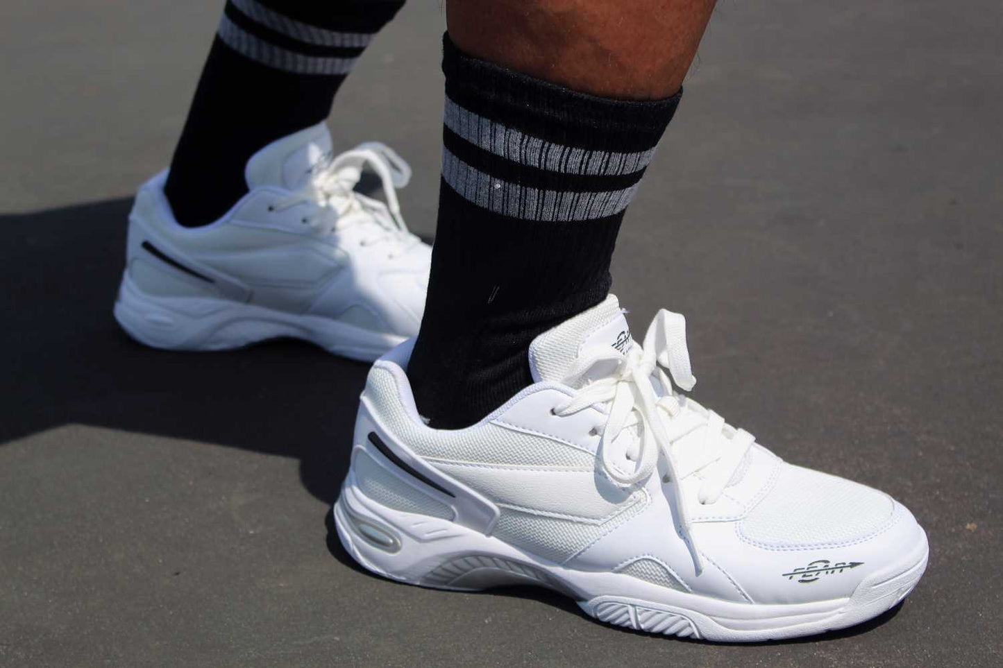 Men's white walking shoes worn with lace-up design and supportive side panel