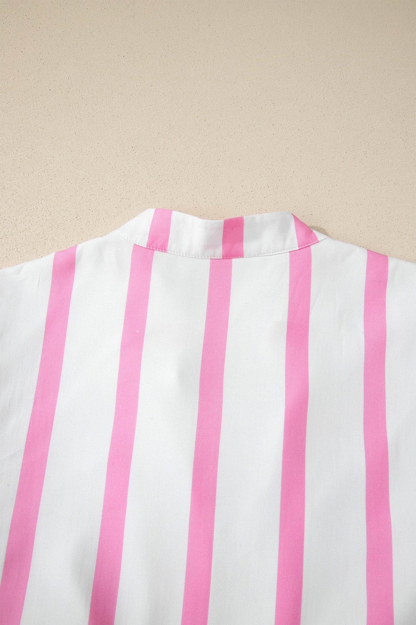 Back view of a pink-and-white striped maxi dress with softly gathered neckline