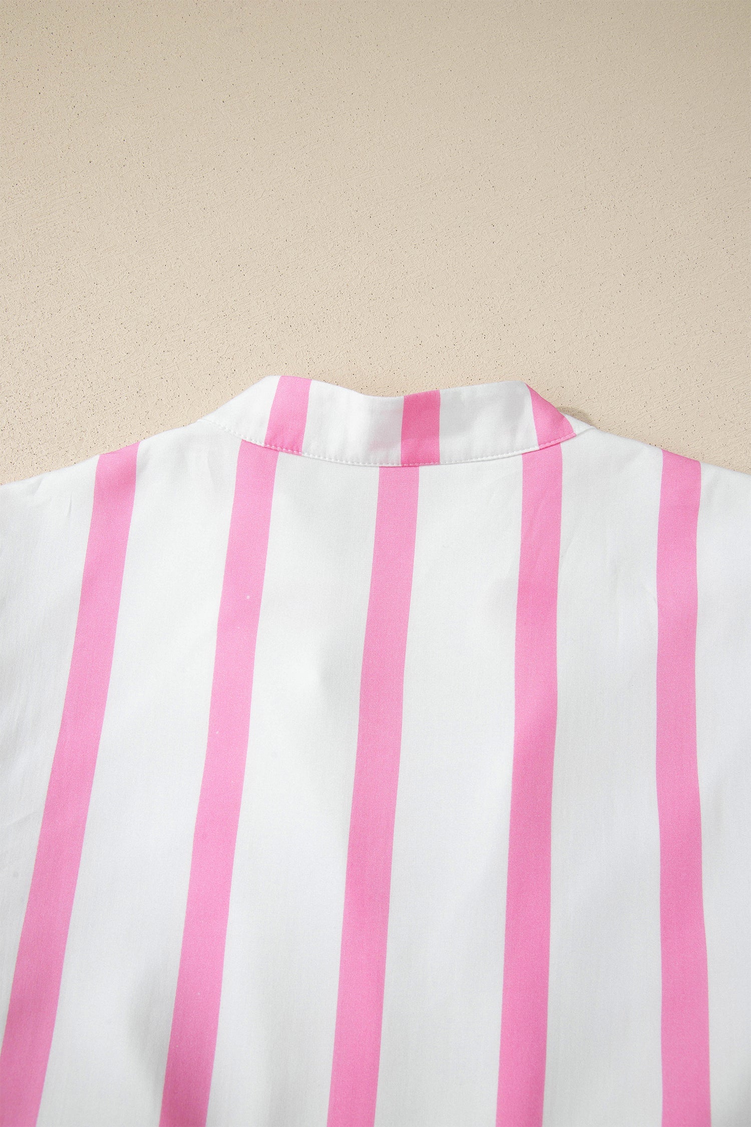 Back view of a pink-and-white striped maxi dress with softly gathered neckline