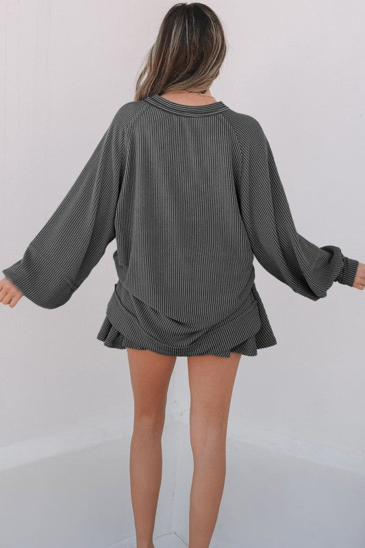 Dark grey corded top and ruffle mini skirt set, long sleeves, back view