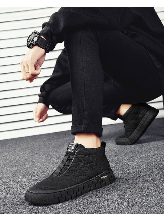 Black high-top lace-up boots with chunky rubber sole worn with black pants