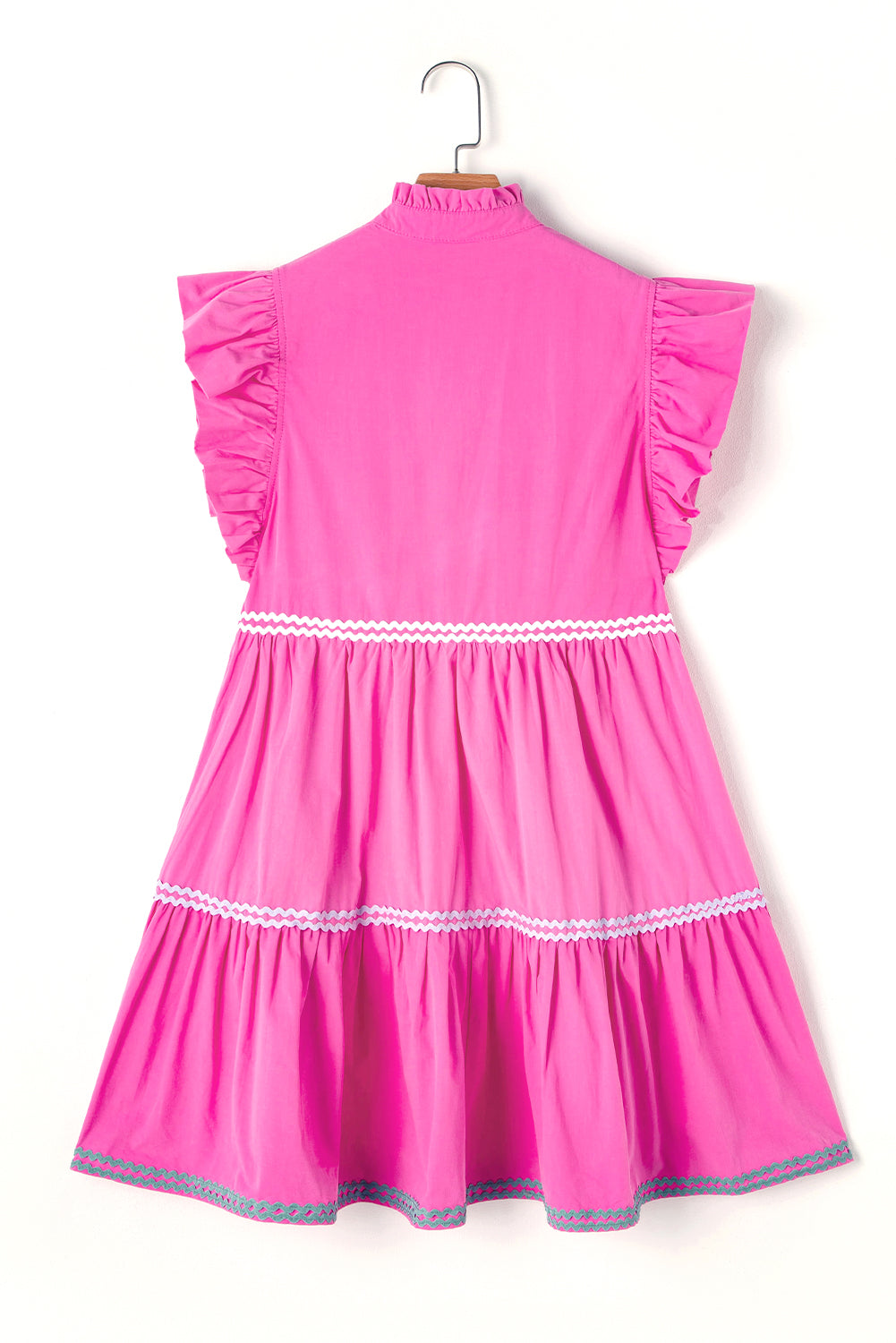 Strawberry pink tiered dress on hanger with ruffled flutter sleeves and zigzag trim