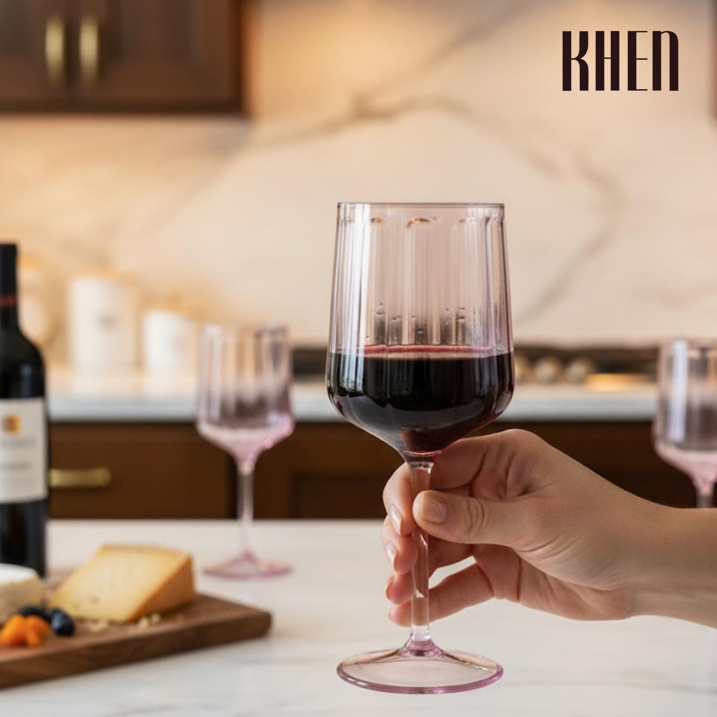 Lilac stemmed acrylic wine goblet with dark red liquid, held by a hand
