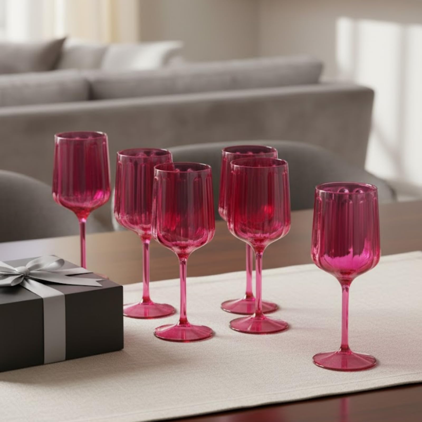 Set of 6 coral-pink acrylic goblets on a table, ribbed cups on stems