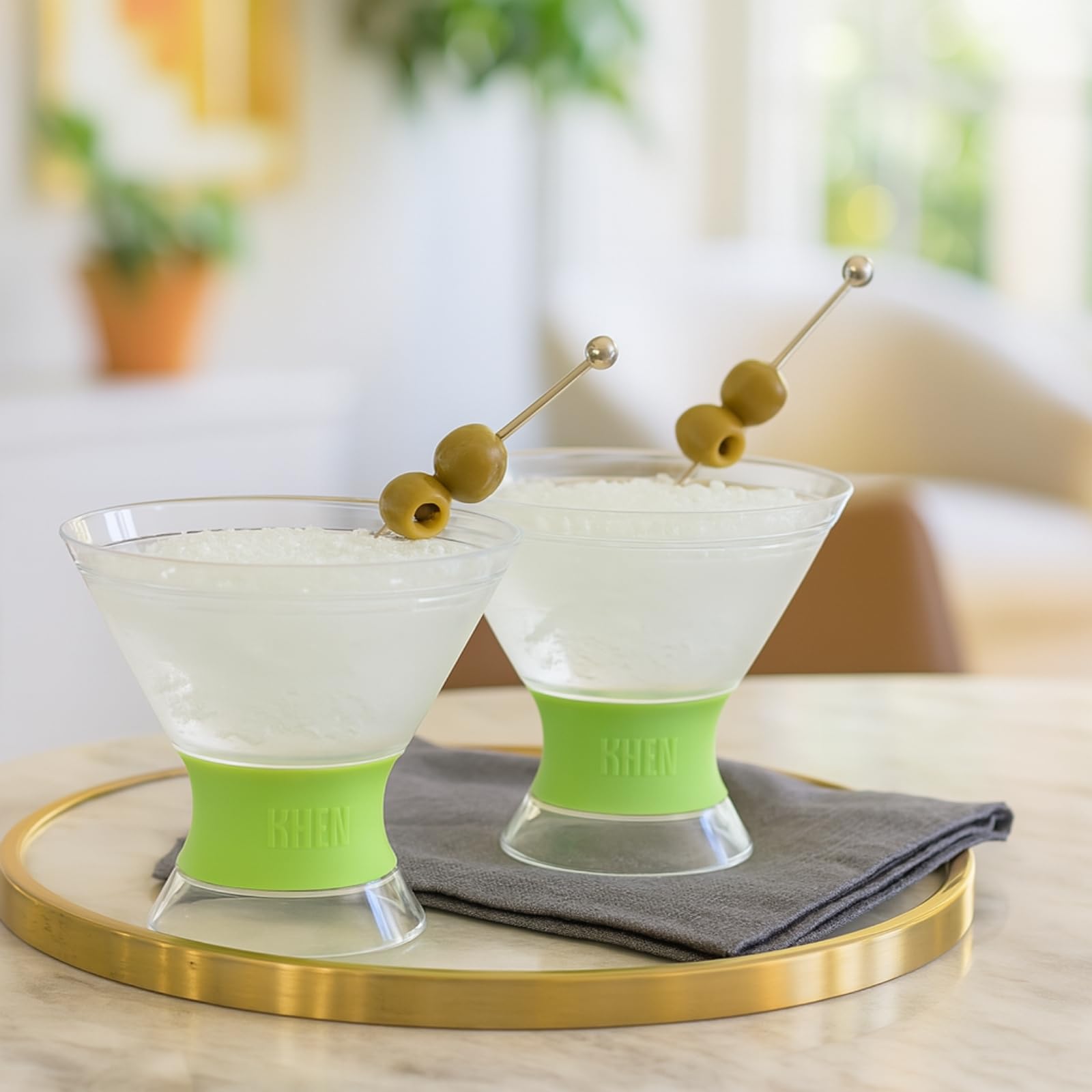 Set of 2 martini glasses with clear cups, lime frosted bases, and olive skewers