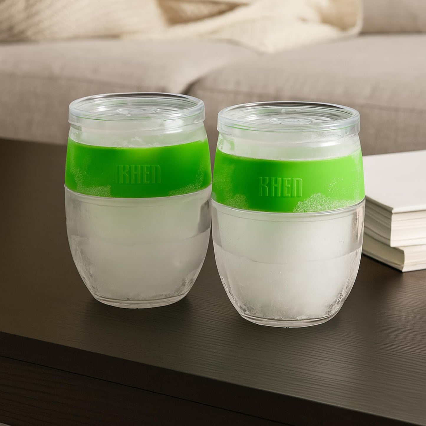 Two stemless acrylic wine glasses with green upper, clear body, dark base band