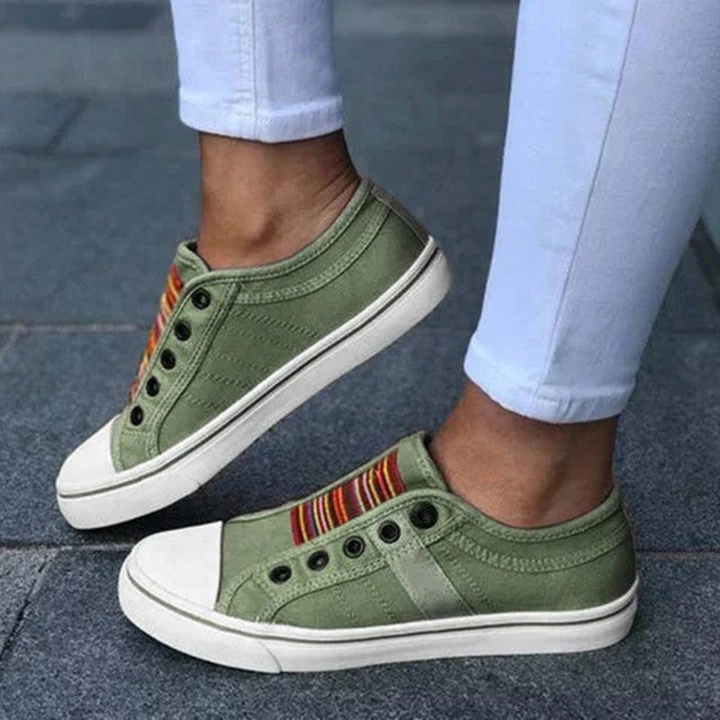 Green canvas round-toe sneakers with elastic gore and rainbow stripe detail, white sole