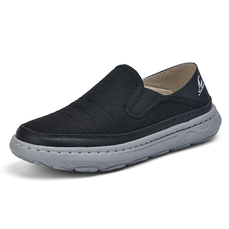 Men's casual travel slip-on shoes in black, textured upper with cushioned gray sole