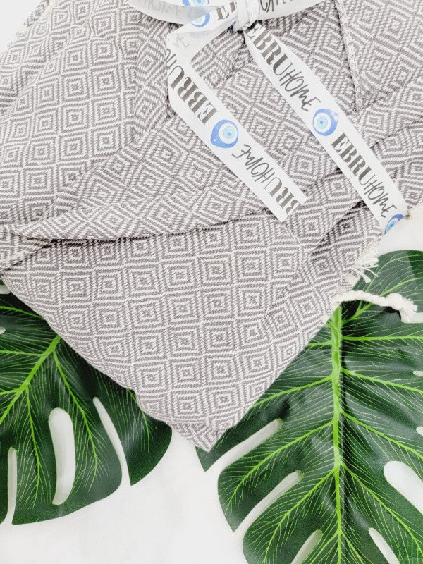 Gray geometric robe fabric close-up with label on tie strap
