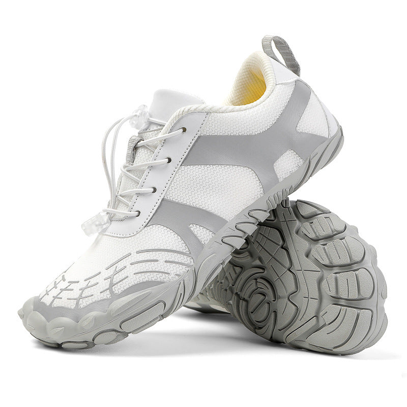 White hiking shoes with lace-up closure and deep tread lugs on the outsole