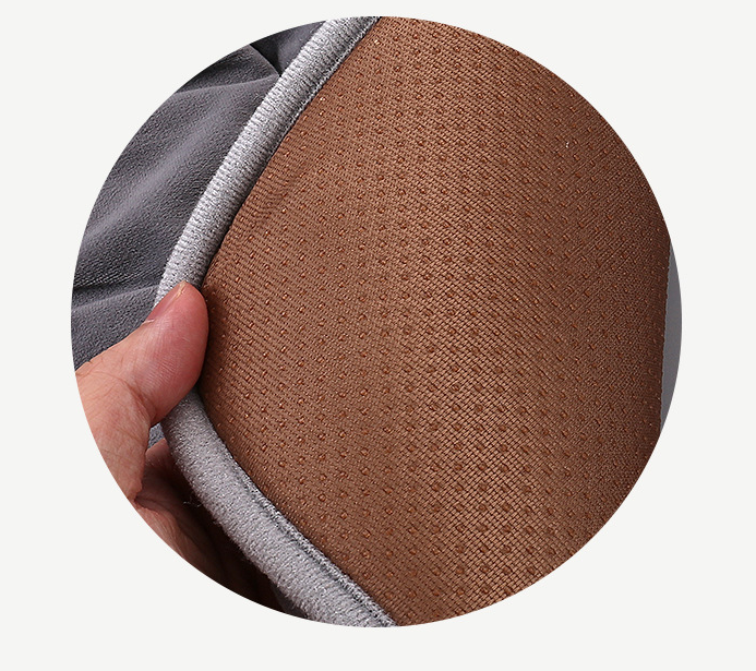 Close-up of textured heating pad fabric edge with stitched seam