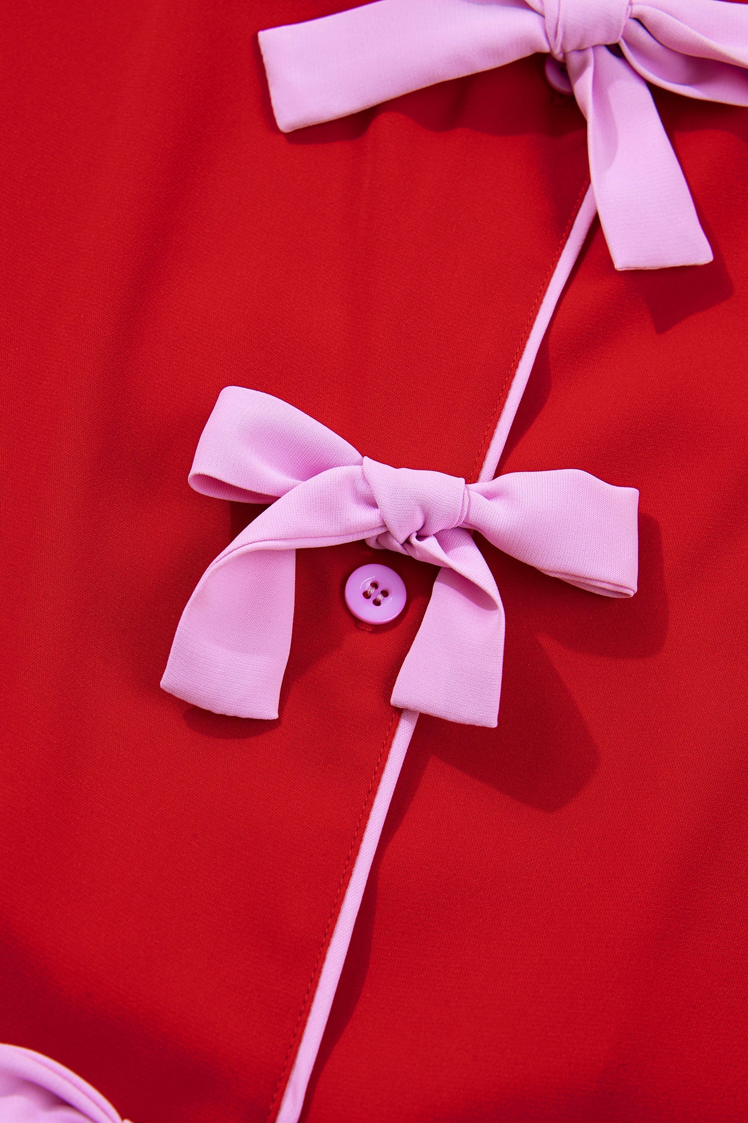Red silky pajama top with bow tie neck and button-front detail
