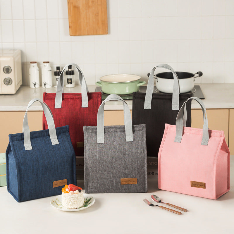 Insulated lunch bags set in blue, dark gray, and pink with light gray top handles