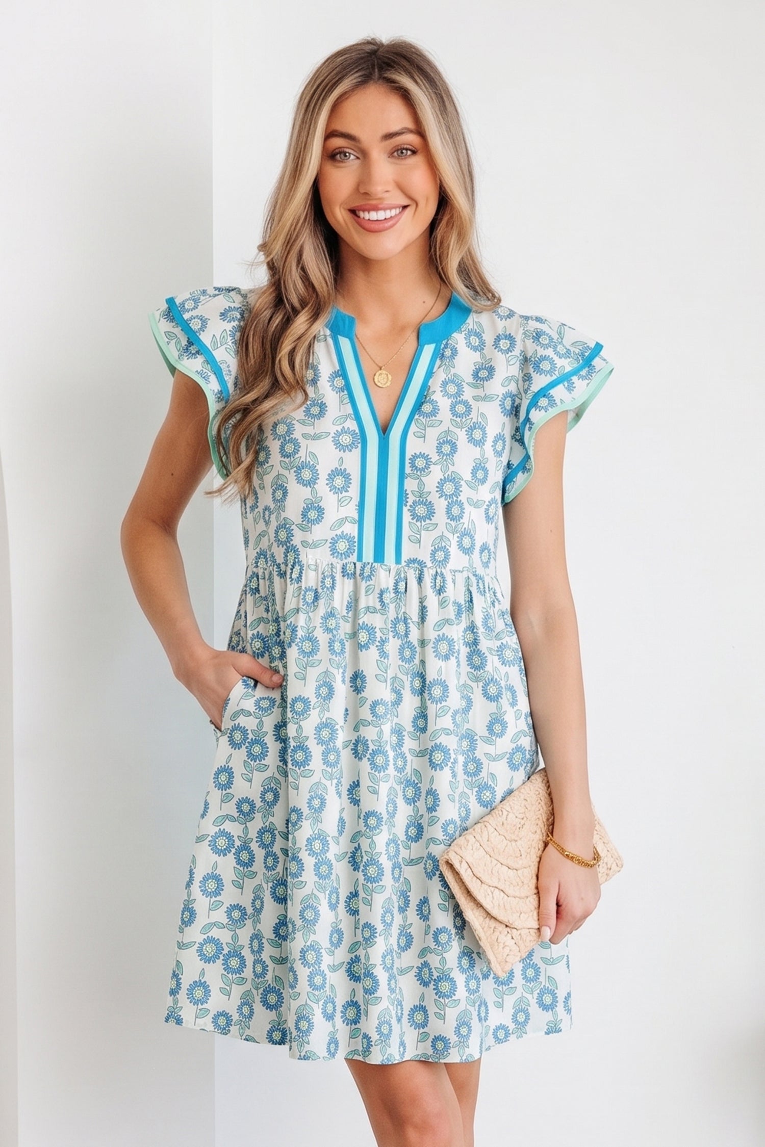 Sky blue mini dress with flutter sleeves and blue-trim V placket, allover floral print