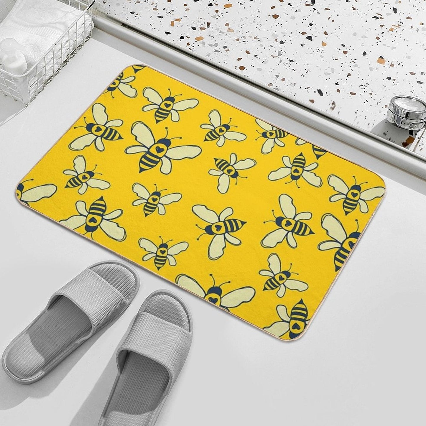 Yellow bee-print bath mat with rounded corners and a thin navy border