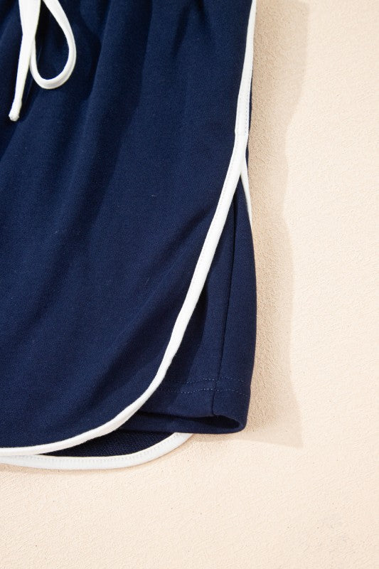 Navy mini skirt hem with white side stripe trim and stitched edge.