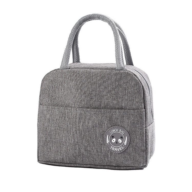 Light gray insulated lunch bag with top handles and round bear logo patch on the front.