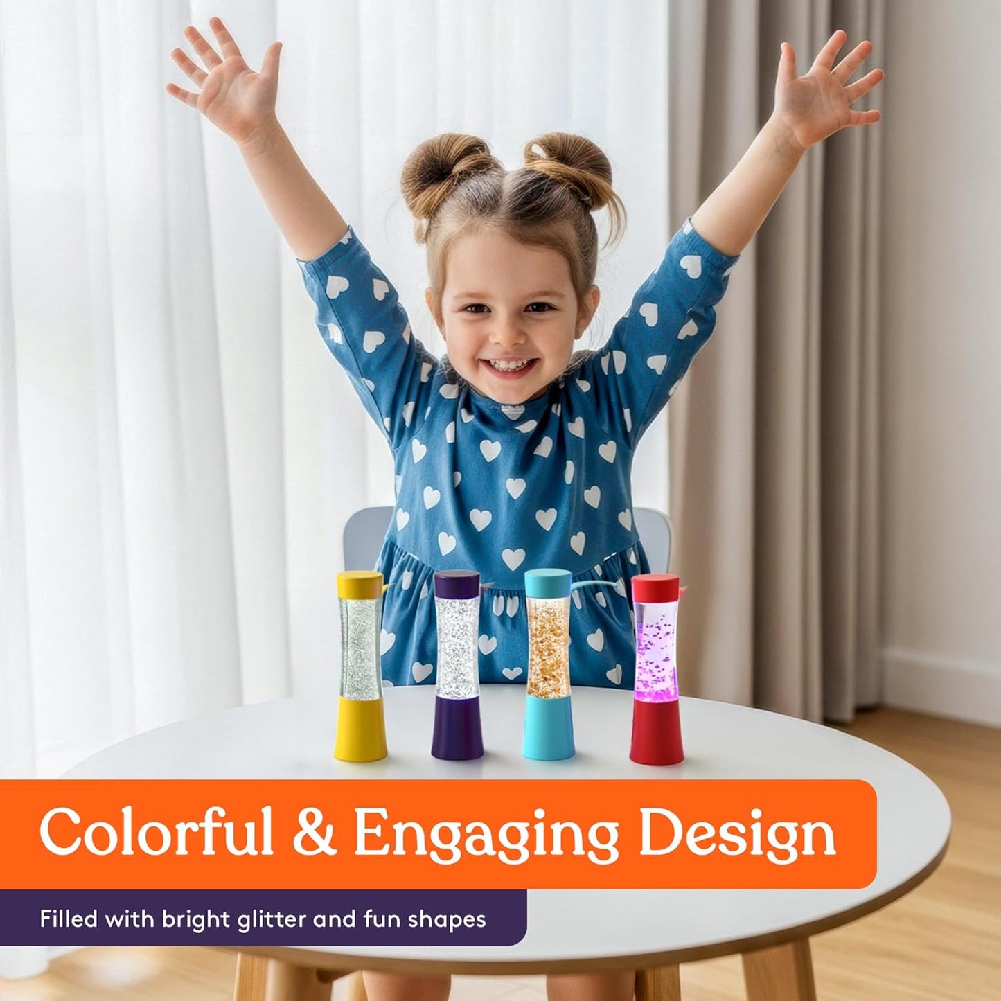 Child standing behind 4 colorful glitter sensory tubes on a round table