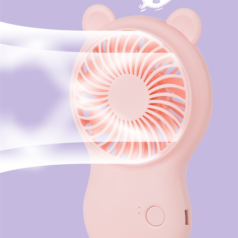 Pink pocket mini fan close-up with round grille, bear-ear top, and control button