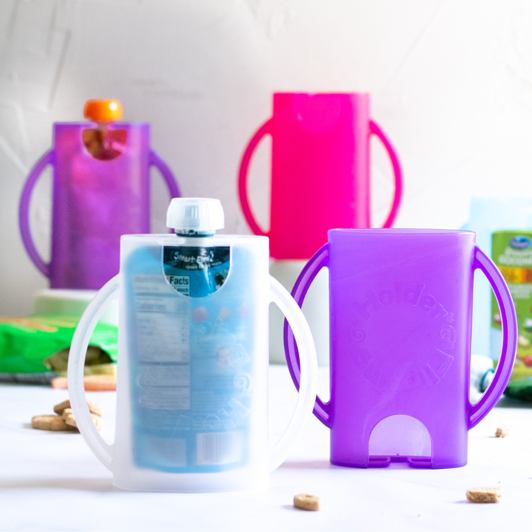 Purple flipping holder with side handles holding a transparent food pouch