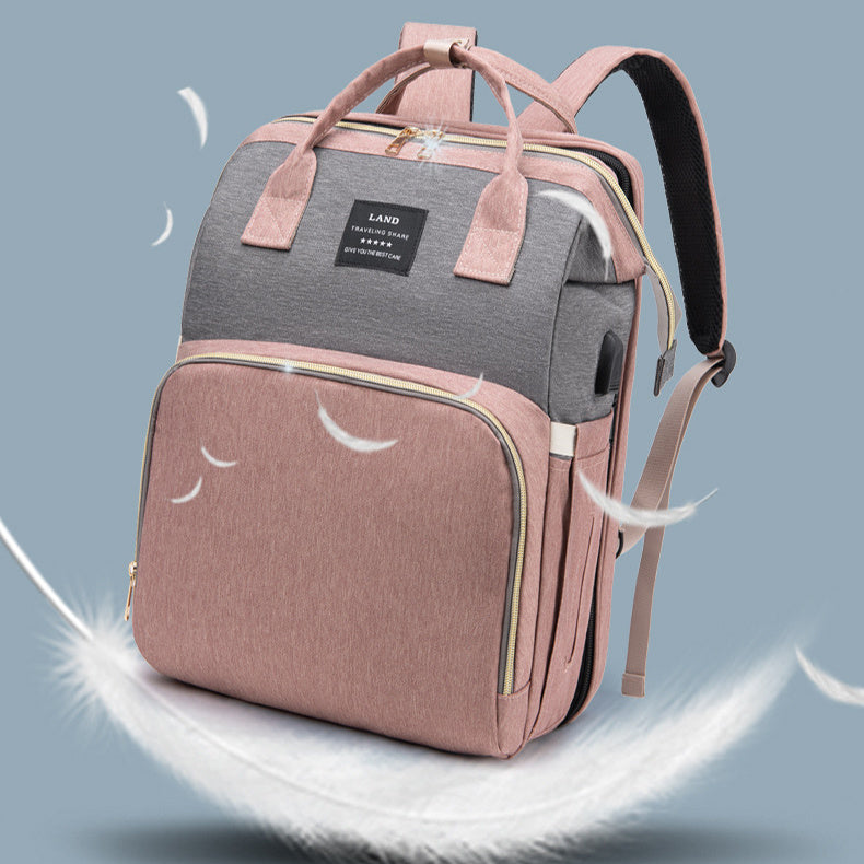 Baby crib backpack, gray and mauve with front pocket and adjustable shoulder strap