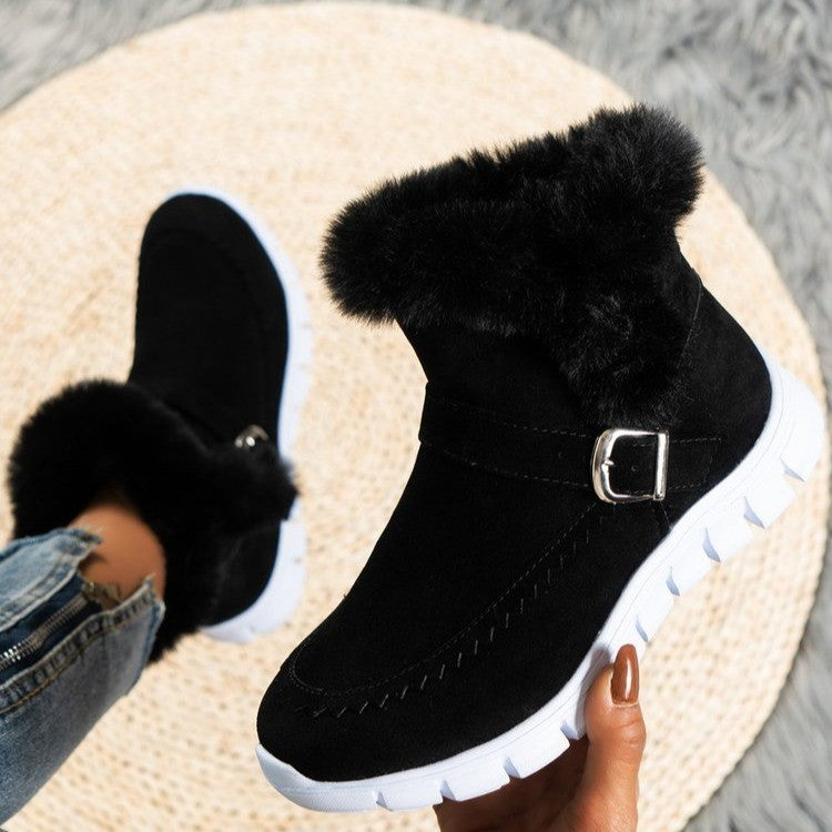 Black ankle snow boot with faux fur cuff, metal buckle strap, chunky white sole