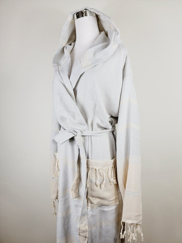 Light white unisex hooded robe with belt tie, front pockets, and fringed cuffs