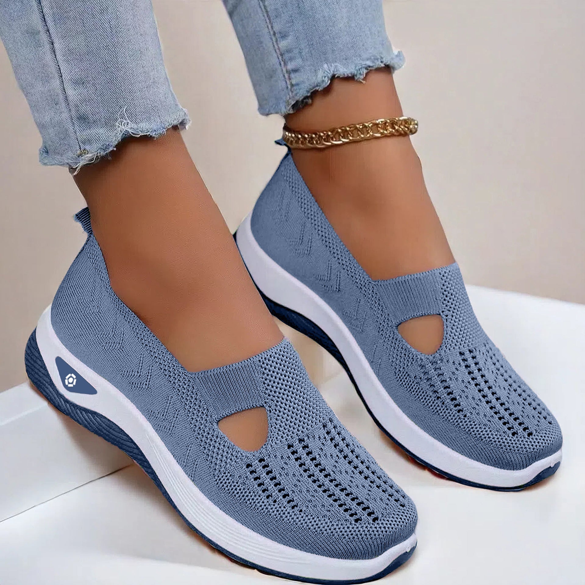 Light blue knit mesh slip-on flats with round cutout and white cushioned sole