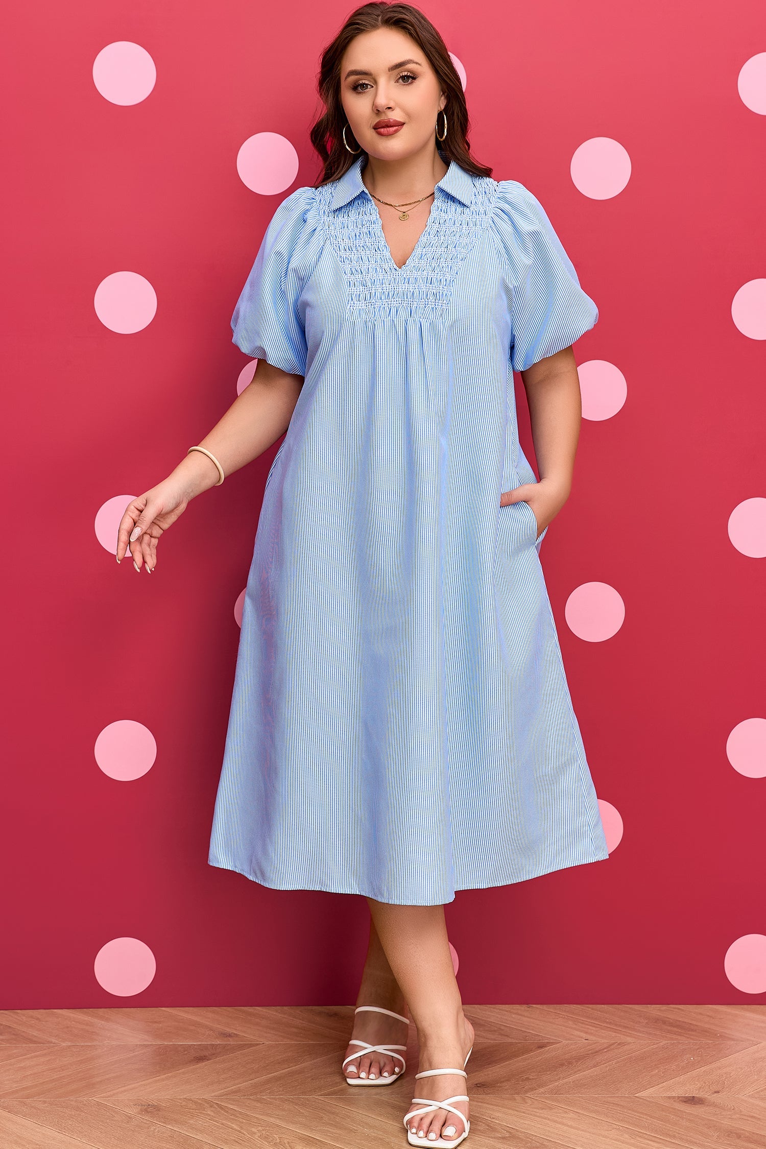 Plus-size light blue striped midi dress with smocked neckline and puff sleeves; full length.