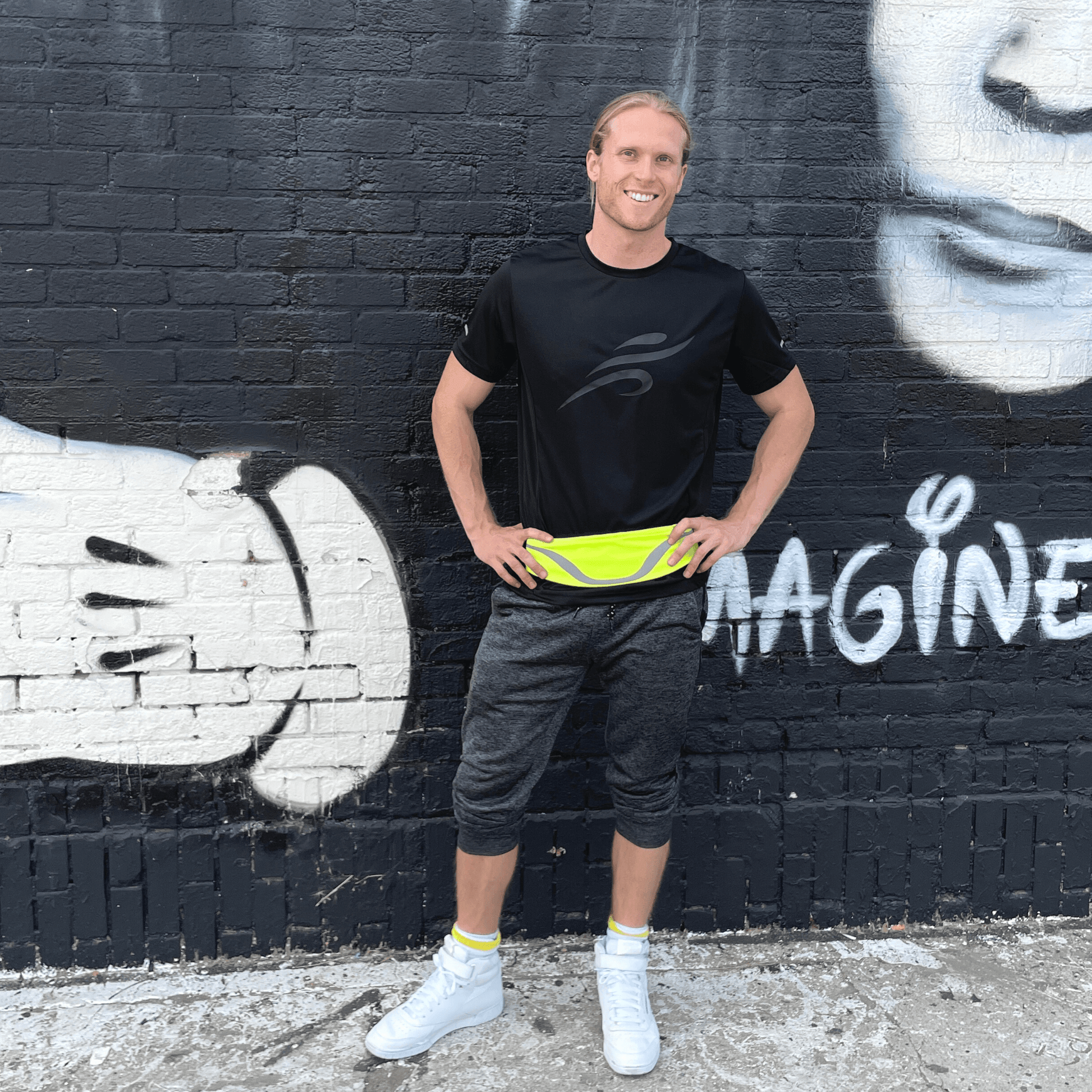 Water-resistant sport waist pack with neon yellow reflective stripe, worn around the waist.