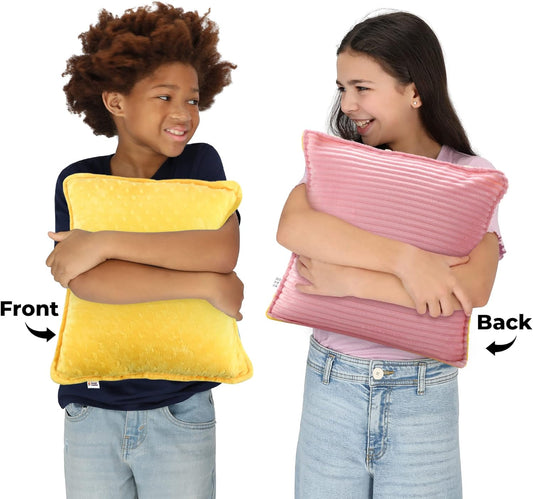 Sensory vibrating pillow hugged; yellow front and pink back plush sides