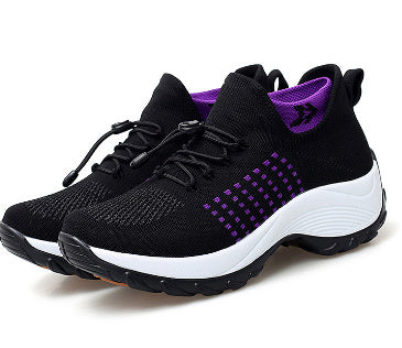 Black knit athletic sneaker with purple detail, lace-up and white cushioned sole