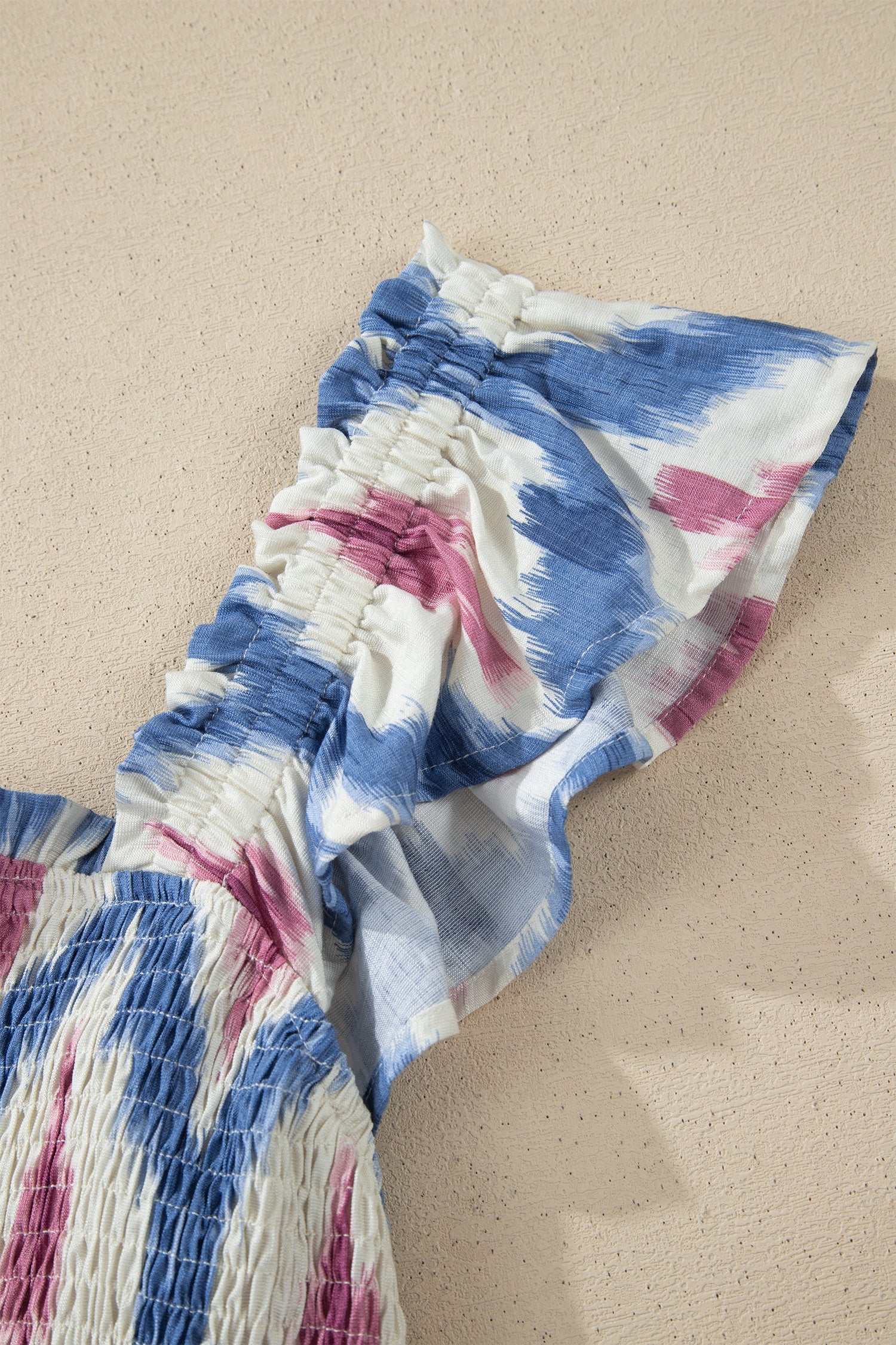 Layered ruffle sleeve with elastic band, sky-blue and pink abstract print.