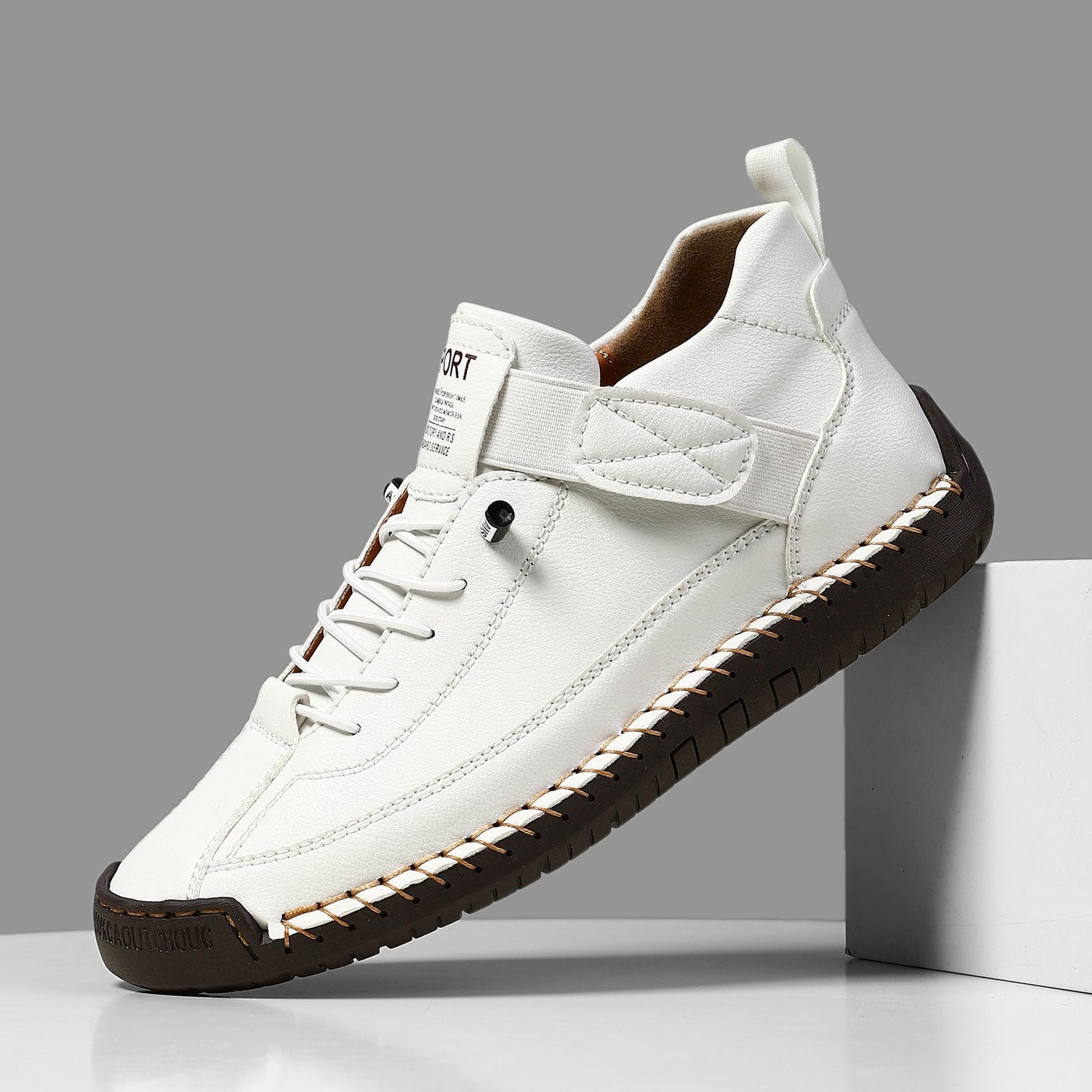 Casual leather boots in white with lace-up front, side strap, and dark ridged tread sole.