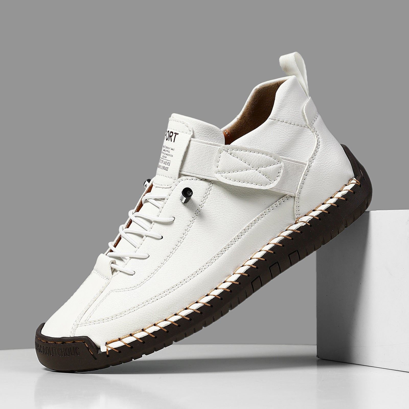 Casual leather boots in white with lace-up front, side strap, and dark ridged tread sole.