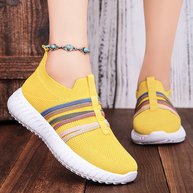 Yellow breathable knit slip-on shoes with striped band and white cushioned sole