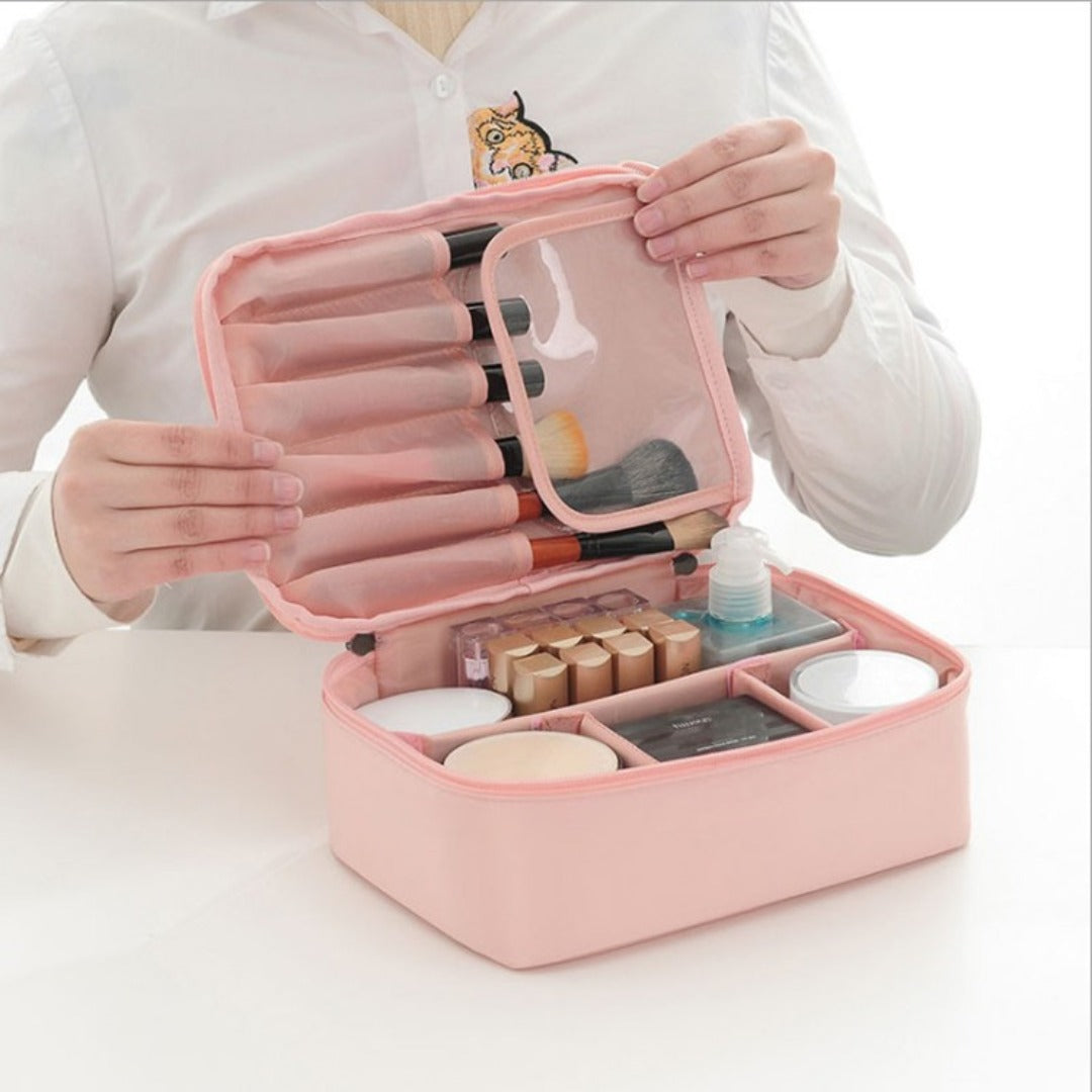 Pink square waterproof cosmetic bag opened with clear organizer pockets and zipper compartments