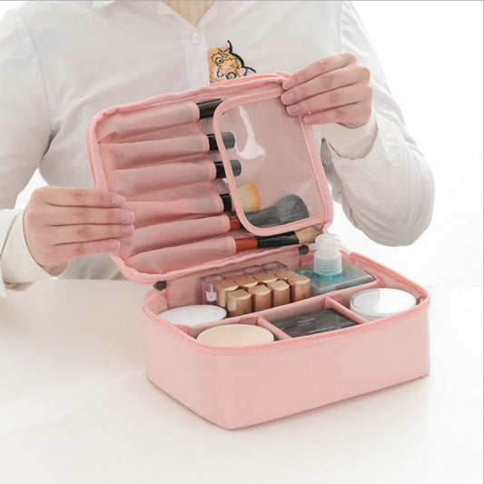 Pink square waterproof cosmetic bag opened with clear organizer pockets and zipper compartments