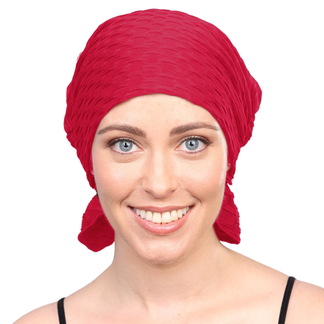 Red chemo beanie with textured knit and gathered side drape