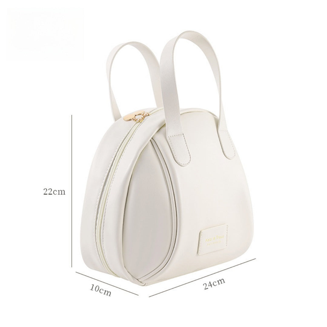 Beige waterproof makeup tote bag with two top handles and front zip pocket