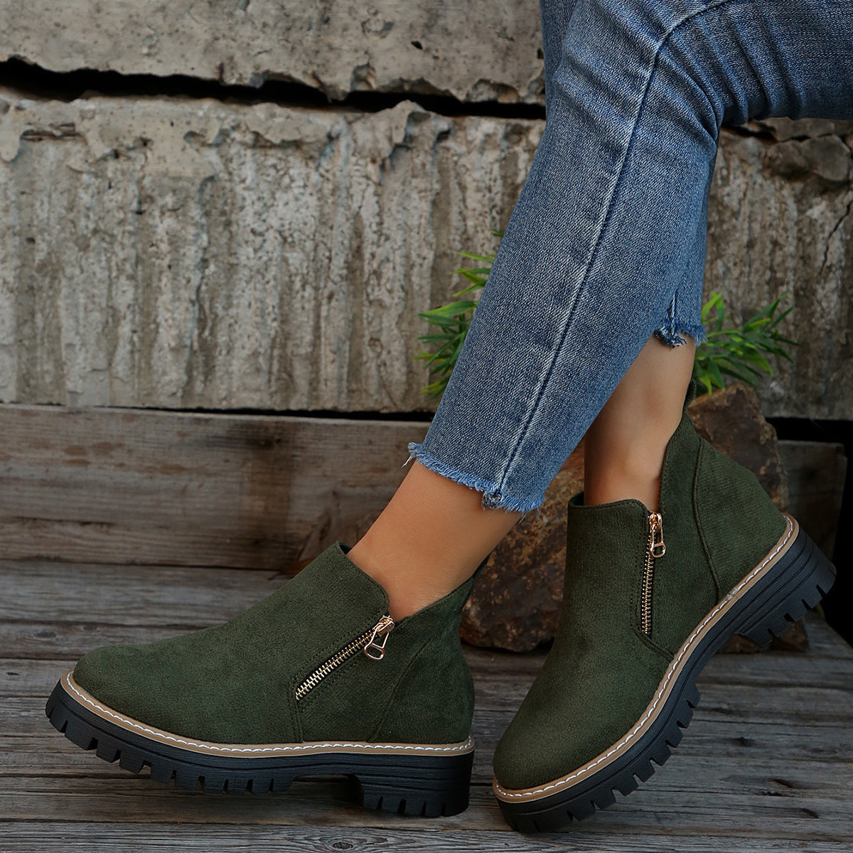 Dark green suede ankle boots with side zipper and chunky black lug sole