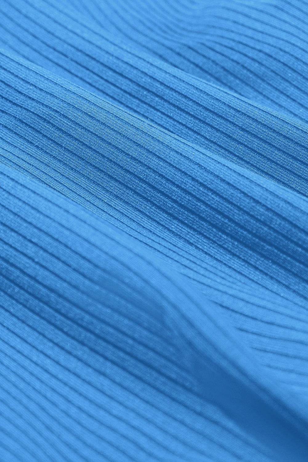 Dusk blue ribbed swim dress fabric close-up with fine horizontal texture.