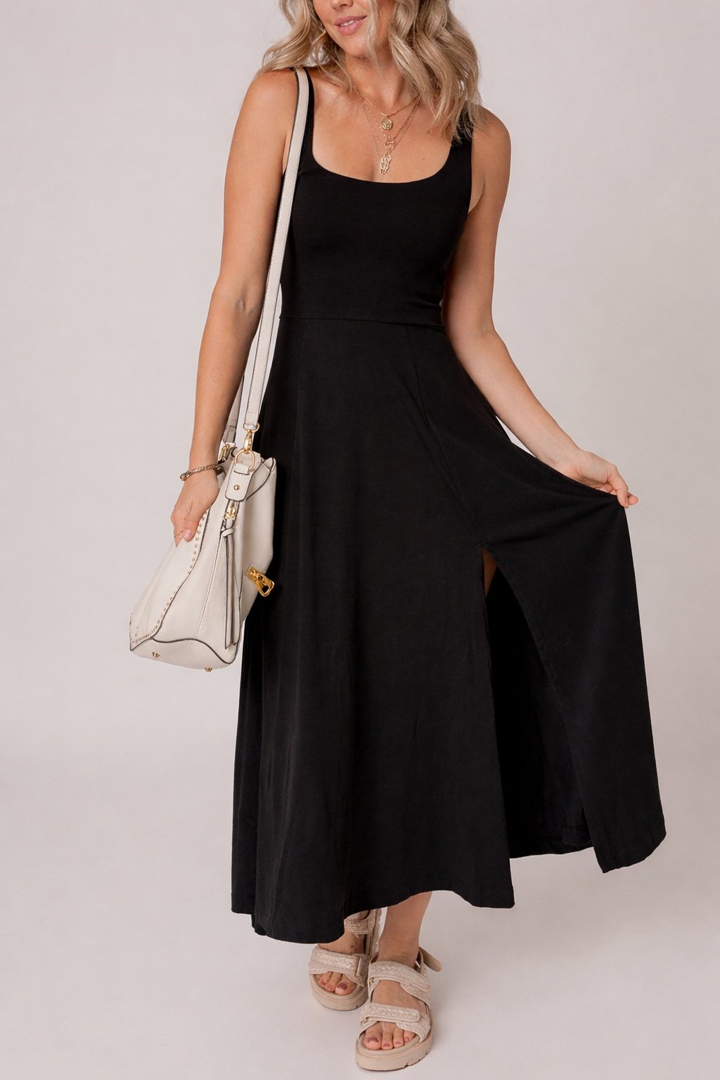 Black sleeveless flared midi dress with scoop neckline and front side slit