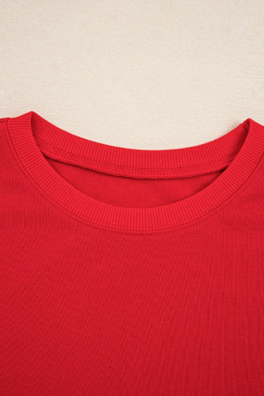 Red pullover top with crew neckline and ribbed collar