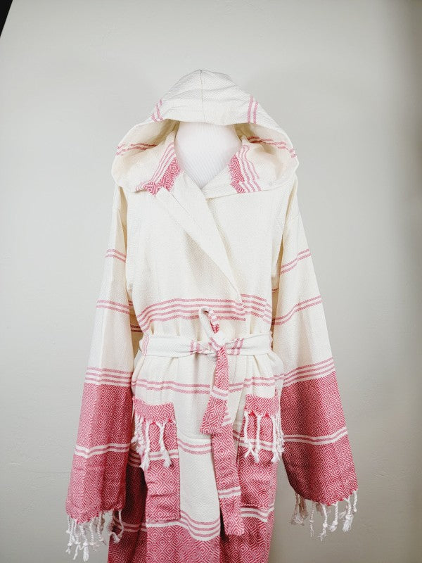 Unisex hooded bathrobe in cream with pink stripes and diamond motifs, tied waist and long fringed cuffs.