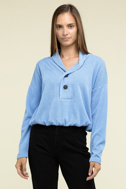Light blue textured pullover top with V-neck, two-button placket, and chest pocket