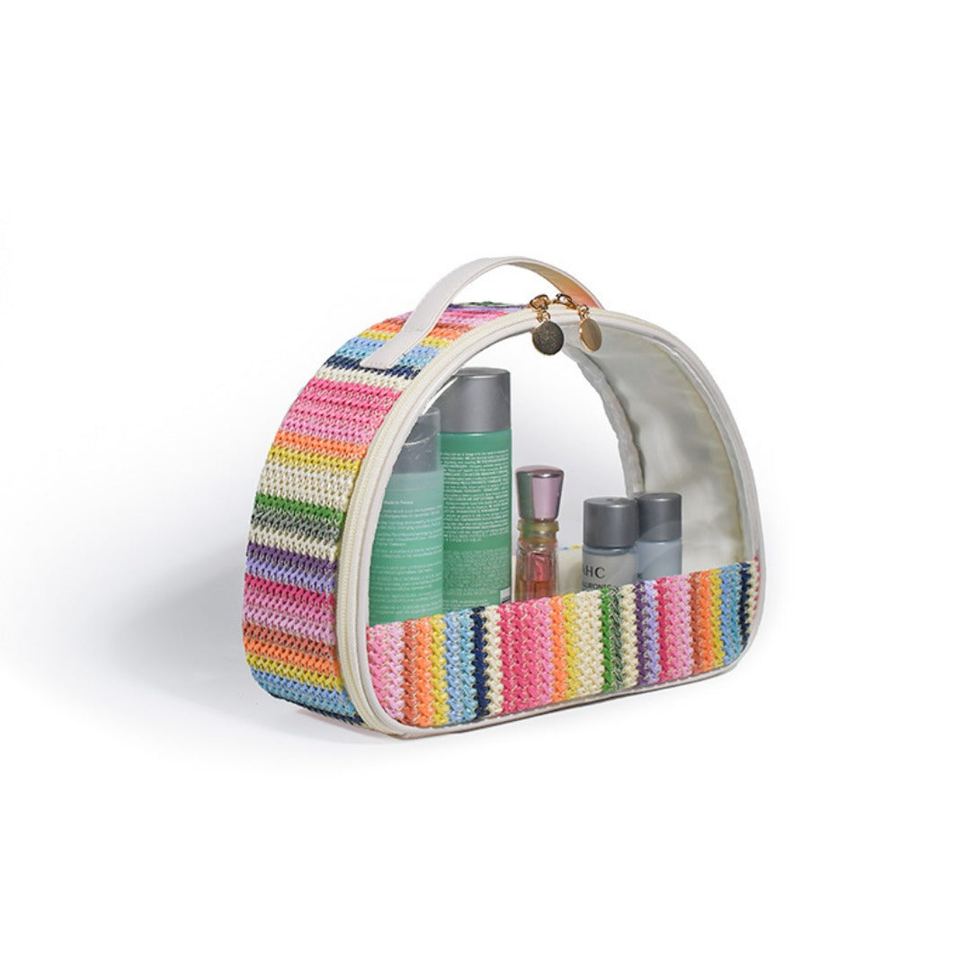 Rainbow striped semicircular clear cosmetic bag filled with toiletries and arched handle