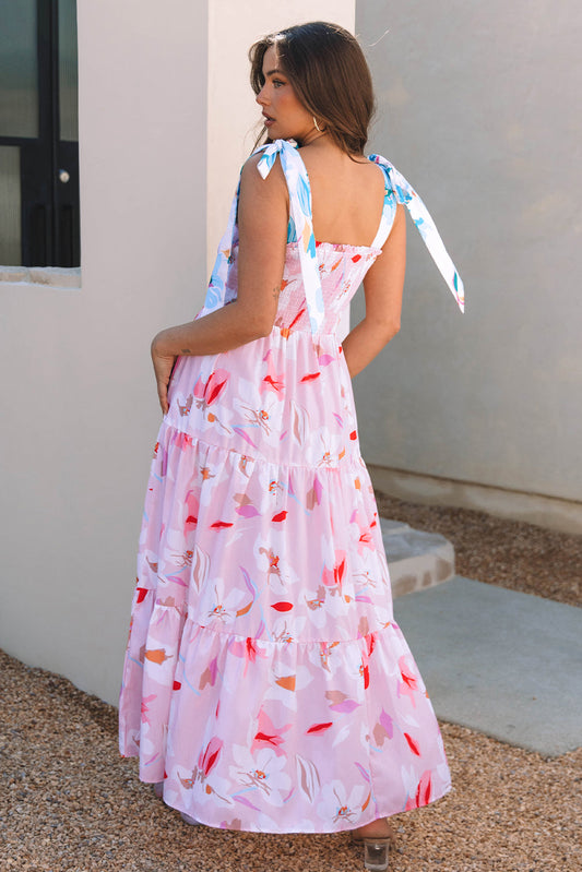 Pink floral maxi dress with smocked bodice, open back, and tied shoulder bows