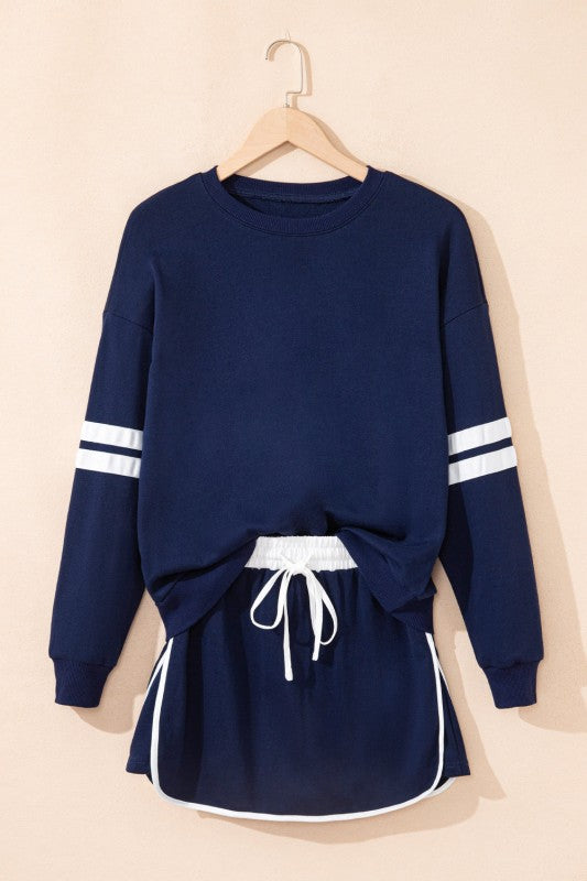 Navy pullover and mini skirt set with white striped cuffs and drawstring waist